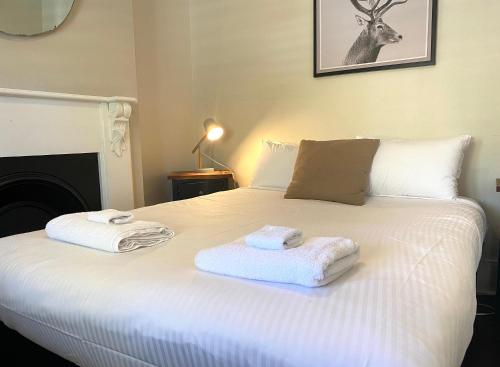 a bedroom with a bed with towels on it at The Edward Townhouses 151 - 157 in Orange