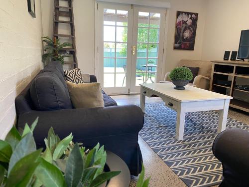 a living room with a couch and a table at The Edward Townhouses 151 - 157 in Orange