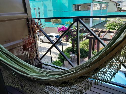 a hammock on the balcony of a building at Pousada Recanto do Aconchego in Florianópolis