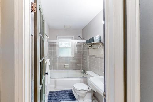 a bathroom with a tub and a toilet and a sink at Sycamore Place Duplex in Atlanta