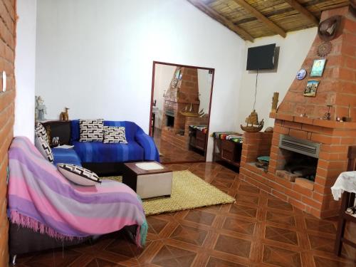a living room with a couch and a fireplace at Kalera Wasi in Cotacachi