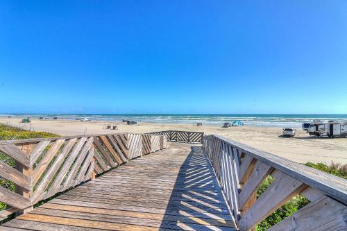 a wooden boardwalk leading to a beach with the ocean at Fairway to Heaven in Port Aransas
