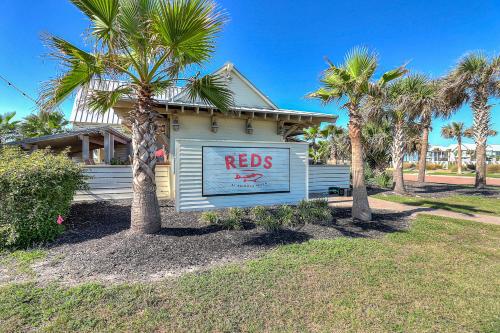 a house with a redds sign on the side of it at Fairway to Heaven in Port Aransas