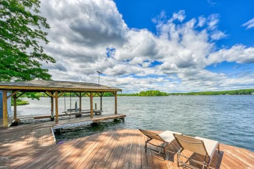 a dock with chairs and a gazebo on a lake at Windswept Cove in Bumpass