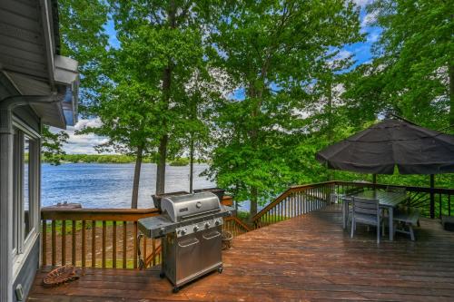 a grill on a deck with a view of the water at Windswept Cove in Bumpass