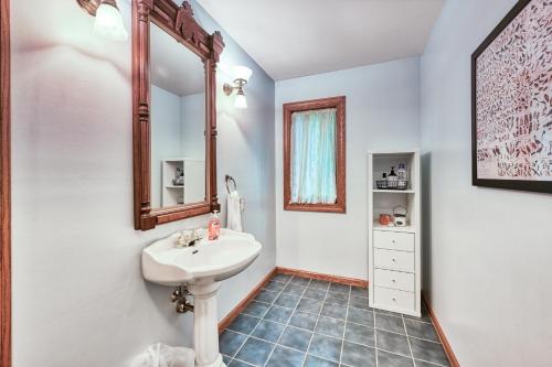 a bathroom with a sink and a mirror at Windswept Cove in Bumpass