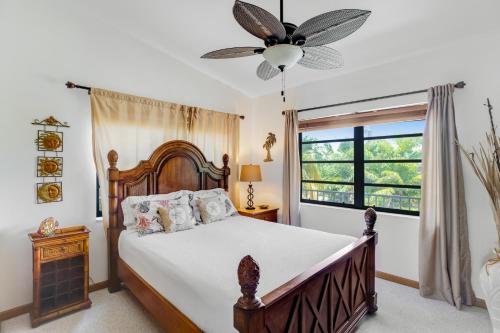 a bedroom with a bed and a ceiling fan at Sombrero Beach Retreat in Marathon