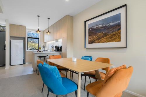 a kitchen and dining room with a table and chairs at Remarkables Retreat Apartment in Queenstown