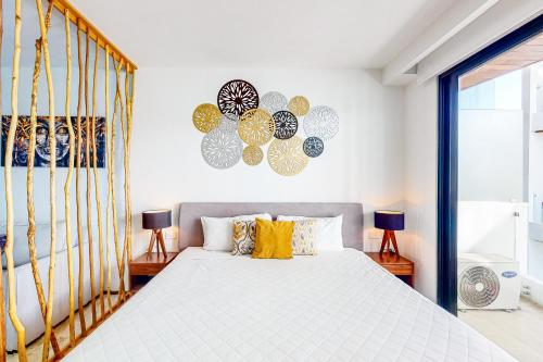 a bedroom with a large bed with yellow pillows at Menesse Midtown 2 Unit 208 in Playa del Carmen