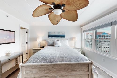 a bedroom with a bed with a ceiling fan at White Marlin 202A in Ocean City