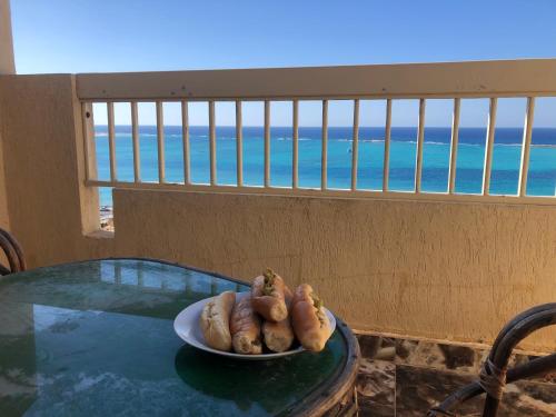 a plate of hot dogs on a table with a view of the ocean at شقه فندقيه مطله على البحر in Marsa Matruh