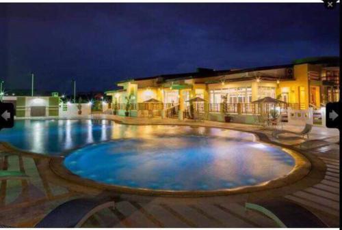 a large swimming pool in front of a building at night at Mansfield w Parking - Fully airconditioned in Angeles