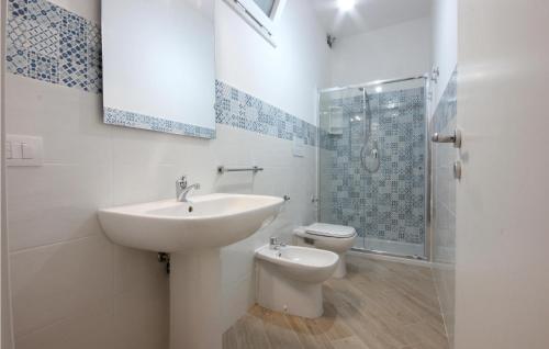 a bathroom with a sink and a toilet and a shower at Pet Friendly Home In Montecorice in Montecorice