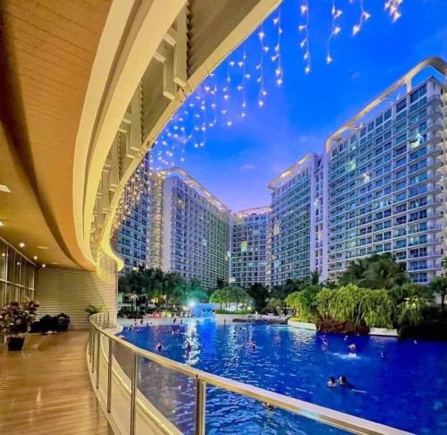 a view of a shopping mall with a large swimming pool at Azure - Acqua Apartments in Manila
