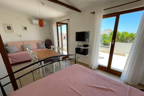 a living room with a table and a couch at Apartments by the sea Povljana, Pag - 21144 in Povljana
