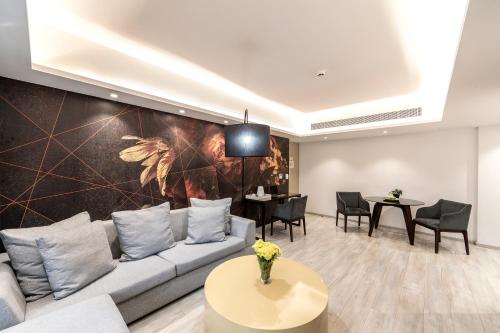 a living room with a couch and a table at Almond Business Hotel in Nicosia