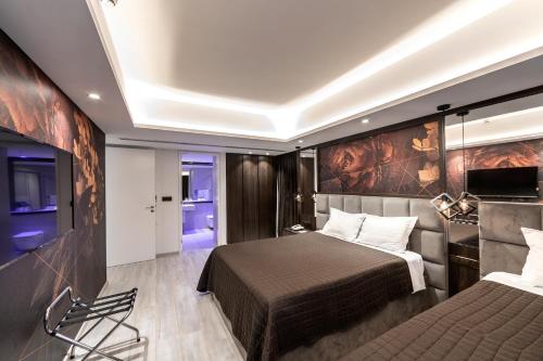 a hotel room with two beds and a tv at Almond Business Hotel in Nicosia