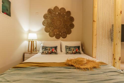 un letto con due cuscini e un cappello sopra di Amaria Studio a Heraklion