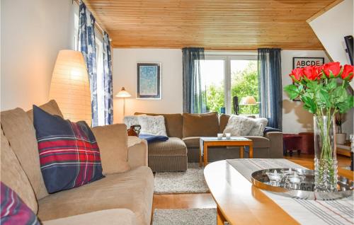 a living room with a couch and a table at 7 Bedroom Awesome Home In Örkelljunga in Orkelljunga