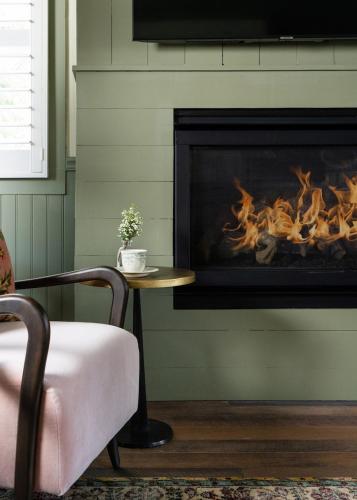 a living room with a table and a fireplace at Le Petit Pali at 8th Ave in Carmel