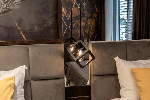 a hotel room with a bed and a wall with a chandelier at Almond Business Hotel in Nicosia