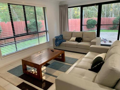 a living room with a couch and a coffee table at Sandstone Point Sleeps 10, 4-bedroom home in Sandstone Point