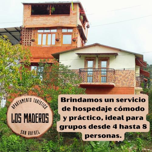 a house with a sign in front of it at Los Maderos San Rafael Antioquia Apartamento Turístico in San Rafael