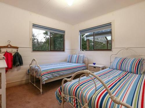 a room with two beds and a couch at Glenvale in Sorrento