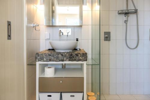 a bathroom with a sink and a shower at The Sands - Apartment 13 - Stay Waiheke in Onetangi