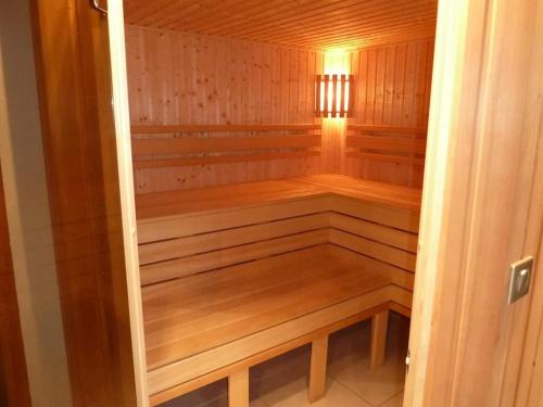een kleine houten sauna met een licht erin bij Classic Mansion in Poperinge with Fenced Garden in Poperinge