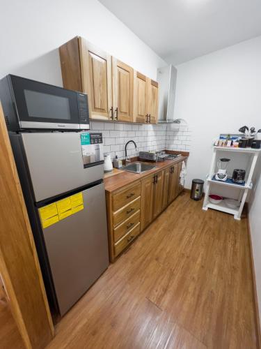 a kitchen with a refrigerator and a sink at Chango's Apartments in Bocas del Toro