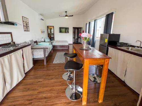 a kitchen and living room with a wooden table at Chango's Apartments in Bocas del Toro