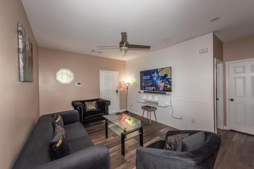 a living room with two couches and a tv at Campbellton D in Atlanta