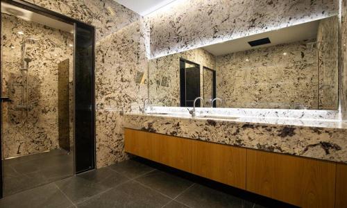 a large bathroom with a sink and a shower at Jeonju Tourist Hotel kkotsim in Jeonju