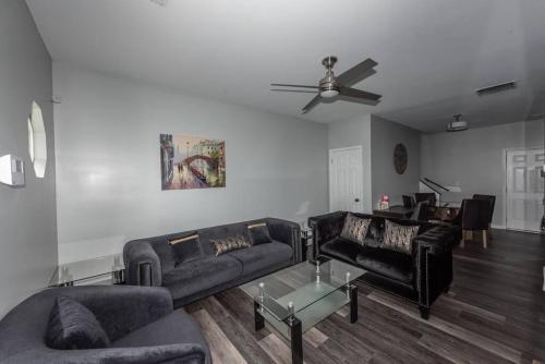 a living room with two couches and a ceiling fan at campbellton B in Atlanta