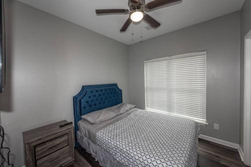 a bedroom with a blue bed and a ceiling fan at campbellton B in Atlanta
