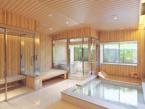 a large bathroom with a tub and a shower at Nanzenji sando KIKUSUI in Kyoto