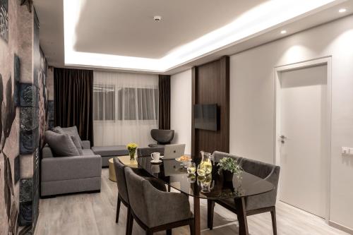 a living room with a table and chairs and a couch at Almond Business Hotel in Nicosia