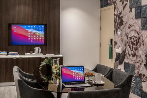 a laptop sitting on a table in a room at Almond Business Hotel in Nicosia
