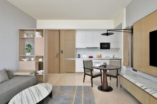 a living room with a couch and a table at Marriott Executive Apartments Navi Mumbai in Navi Mumbai