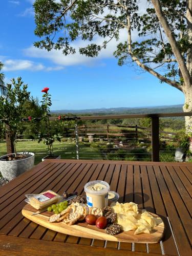 uma bandeja de comida numa mesa de madeira com comida em Jetavana em Eudlo