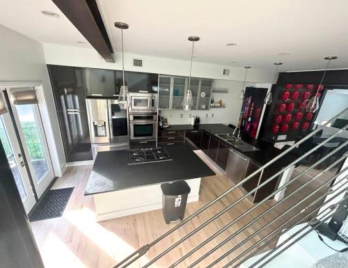 a kitchen with stainless steel appliances and black and white at Tokyo in Denver, Speakeasy Room & Skyline Rooftop In Central RiNO in Denver