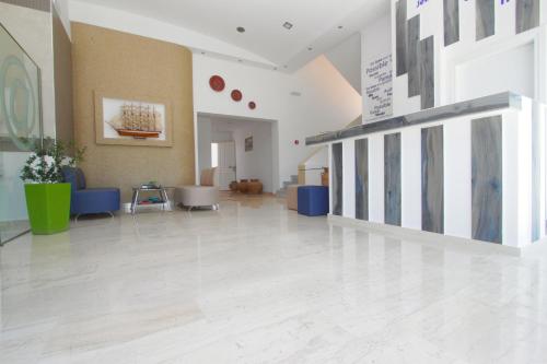 a large room with a lobby with white floors at Lindian Jewel Hotel and Villas in Líndos