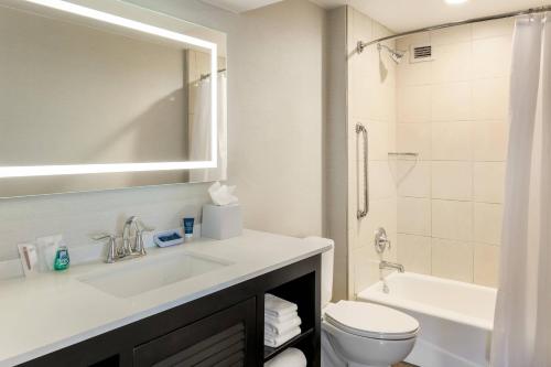 a bathroom with a sink and a toilet and a shower at Four Points by Sheraton San Diego Downtown Little Italy in San Diego