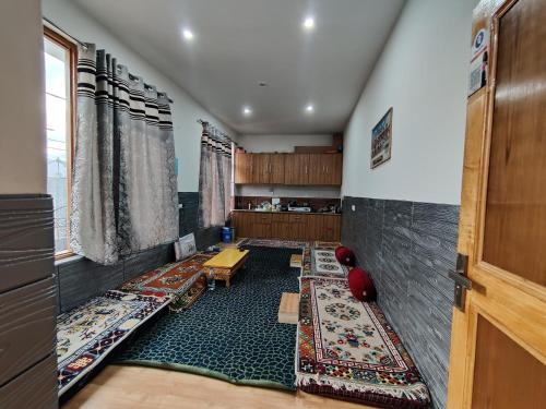 a room with rugs on the floor and a door at Lynx near Leh airport in Leh