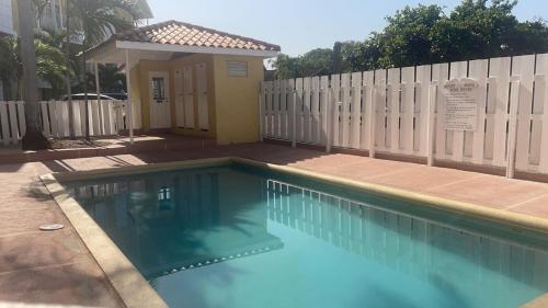 a swimming pool in front of a fence at Finest Accommodation Apt # 424 Marley Manor Block 4 6 Marley Rd Kgn 6 in Kingston