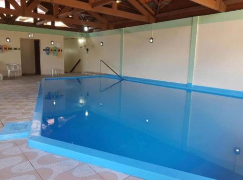 a large swimming pool in a room at Pousada do Serrano - Rua Torta in Gramado