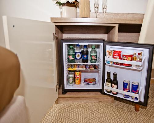 a small refrigerator with its door open in a room at Hotel Soldo in Međugorje