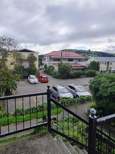 a group of cars parked in a parking lot at Akaroa Village Inn in Akaroa
