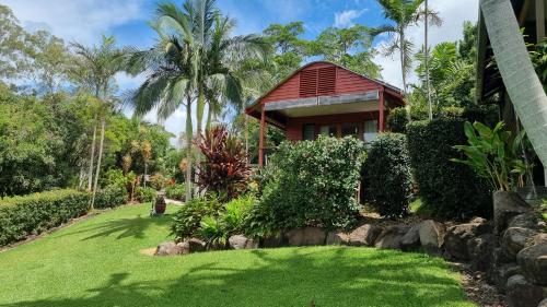 a house with a green lawn in front of it at Jetavana in Eudlo